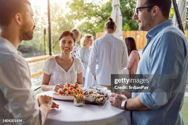 colleagues at the banquet, during the team building event - chat canapé stock pictures, royalty-free photos & images