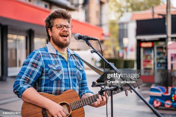 guitar player on a city square - street musician stock pictures, royalty-free photos & images