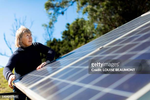 senior female farmer checks on her solar panels - farmer australia ストックフォトと画像