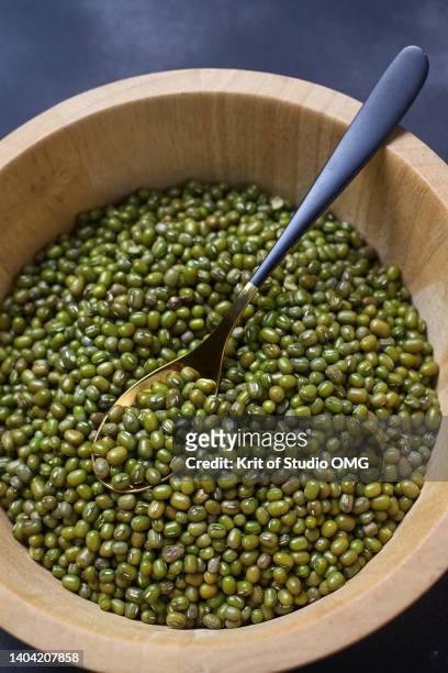 the mung beans in a wooden bucket - mung bean stock pictures, royalty-free photos & images