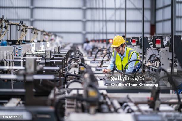 engineers working at heavy industry manufacturing factory - production line worker stock pictures, royalty-free photos & images