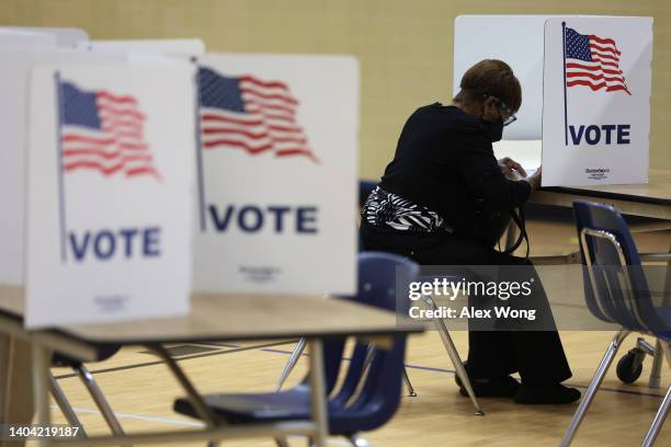 Voter casts her ballot at a polling station at Rose Hill Elementary School during the midterm primary election on June 21, 2022 in Alexandria,...