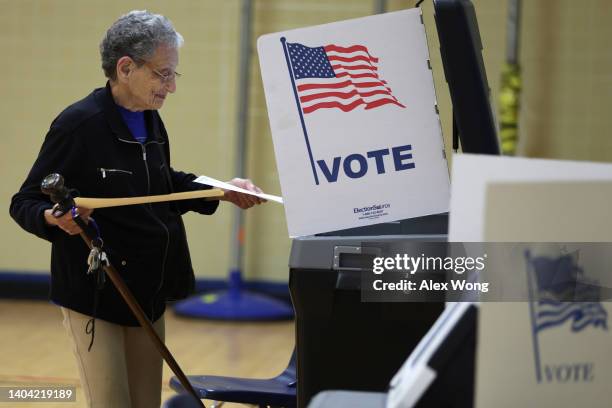 Voter casts her ballot at a polling station at Rose Hill Elementary School during the midterm primary election on June 21, 2022 in Alexandria,...