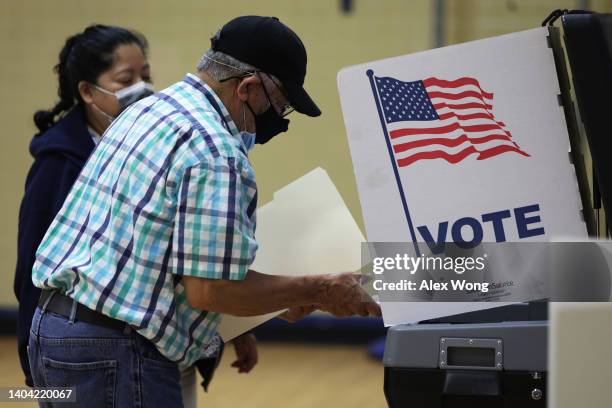 Man casts his ballot at a polling station at Rose Hill Elementary School during the midterm primary election on June 21, 2022 in Alexandria,...