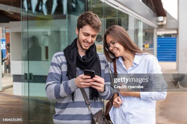 couple buying boat ticket via cell phone - passenger train stockfoto's en -beelden