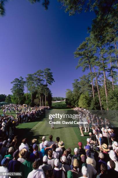 Spectators look on as Fred Couples from the United States drives off the 18th Tee during the US Masters Golf Tournament on 11th April 1998 at the...