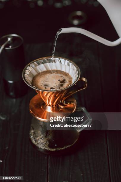 brewed coffee is made by pouring hot water onto ground coffee beans, then allowing to brew. - brewed coffee stock-fotos und bilder