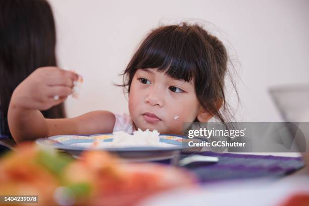 young girl plying with the food - picky eater stockfoto's en -beelden