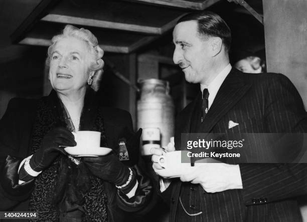 Clementine Churchill and J Arthur Rank have a cup of tea at the YWCA canteen at the Odeon, Leicester Square, during the premiere of 'The Phantom of...