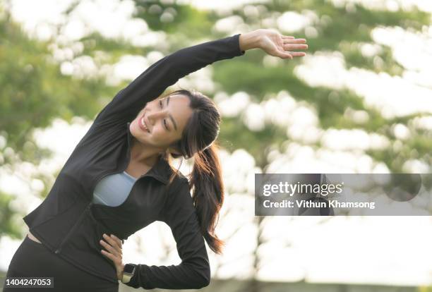 young asian women sports exercise and runs at public park. - day of yoga in bangkok stock-fotos und bilder