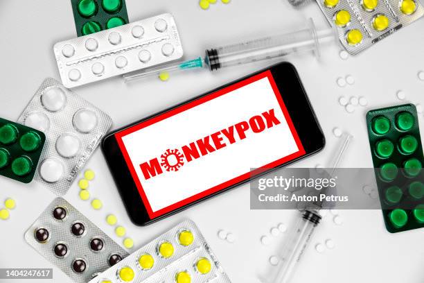 smartphone with inscription monkeypox virus. spread of the new virus in europe - virus pox photos et images de collection