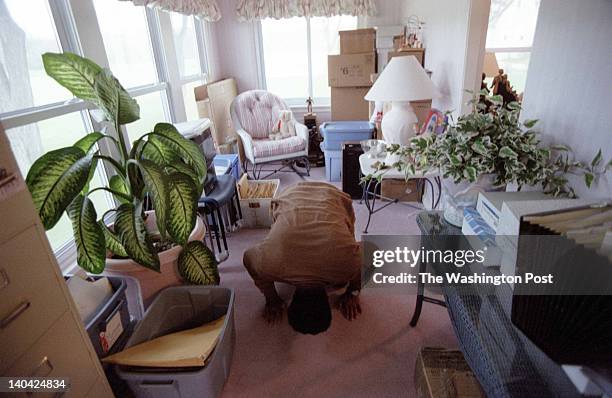 Day with Muhammad Ali on his farm in Berrien Springs, Michigan, May 14, 1997. Ali kneels down to pray. He prays five times a day.