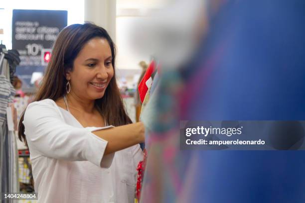 young latin pretty woman shopping in an outlet shopping in miami beach, florida, usa - latin american and hispanic shopping bags bildbanksfoton och bilder