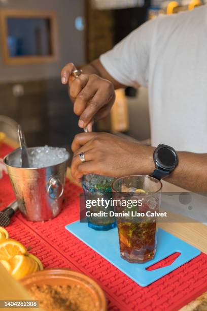 bartender stirring a mojito at a bar - dominican ethnicity stock pictures, royalty-free photos & images