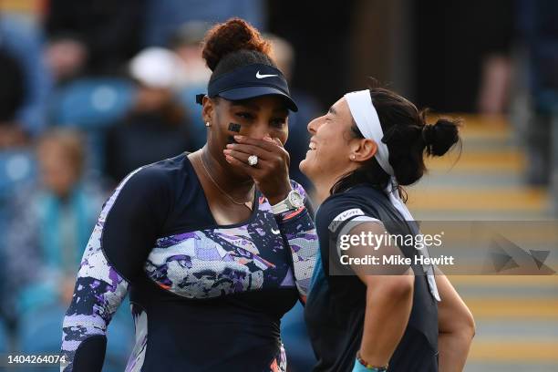 Serena Williams of United States of America and Ons Jabeur of Tunisia interact during their Women's Doubles Round One match against Marie Bouzkova of...