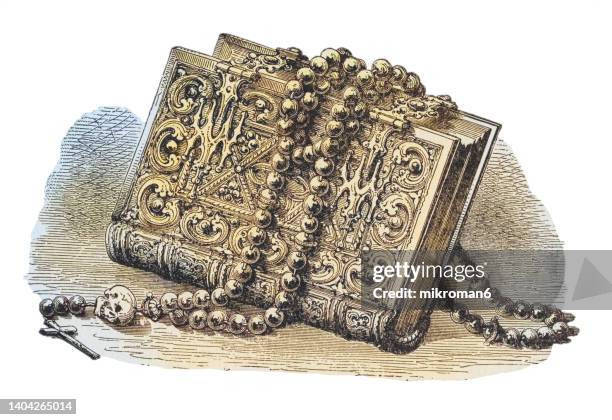 old engraved illustration of ancient book and rosary - library old books stock-fotos und bilder