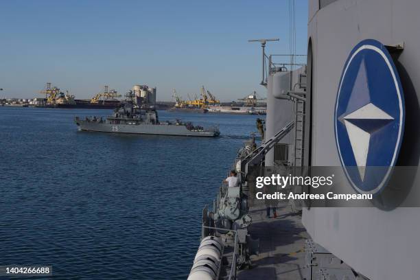 Military ship sails next to Romanian Navy King Ferdinand frigate during the "Shield Protector 22" military exercise, in the port of Constanta, on...
