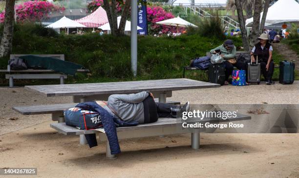 Homeless man sleeps in the six-acre Tongva Park, a relatively new urban community oasis filled with interesting architecture, walkways, landscaping,...