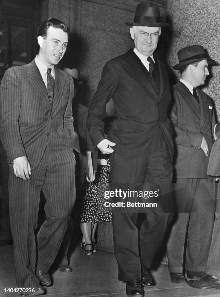 Martin Manton dignified Jurist is flanked by some of his counsel as he leaves court upon being pronounced "guilty." Manton, formerly the tenth...