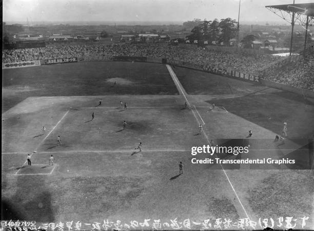 This photograph shows a high school championship Japanese baseball game being played at Koshien Stadium in Osaka, Japan in 1920.