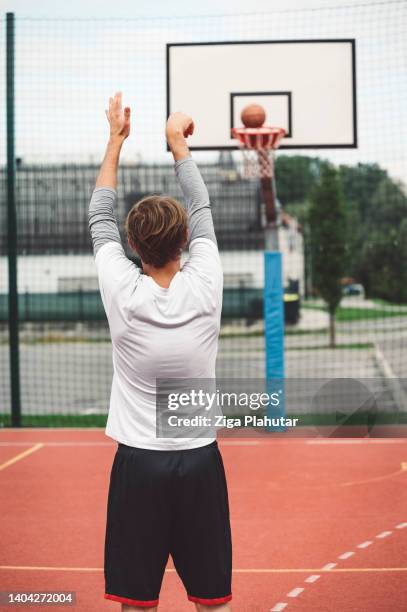 young athlete practicing his shoot - streetball stock pictures, royalty-free photos & images