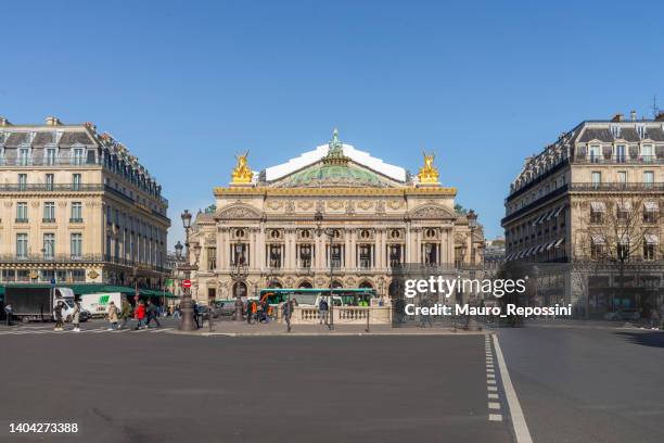 people walking in the place de l´opera (opera square) next to the palais garnier opera house (opera du paris) at paris city, france. - grand opera house stock pictures, royalty-free photos & images