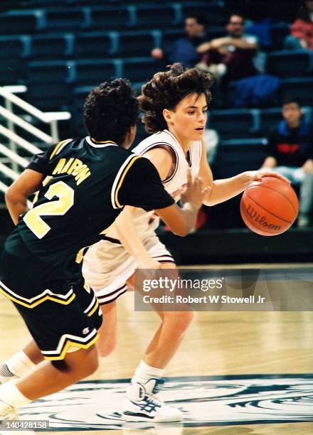 American basketball player Debbie Baer of the University of Connecticut drives past an Iowa defender, Gampel Pavilion, Storrs, CT, 1991.