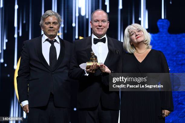 Producer Cyril Denvers and Producer Candice Souillac pose with the Prince Rainier III Special Prize Award for 'Les éclaireurs de l'eau' next to...