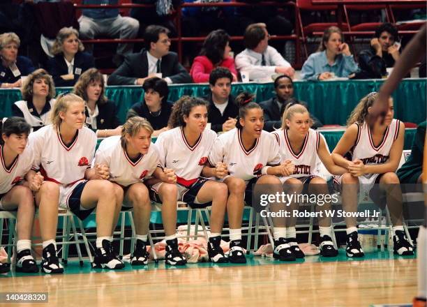 The University of Connecticut bench leans forward in anticipation during the last seconds of the championship game victory against the University of...