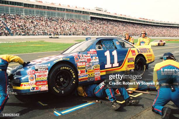 The pit crew for Brett Bodine and the Lowe's car troubleshoots the engine during a Winston Cup race, Charlotte, NC, 1997.