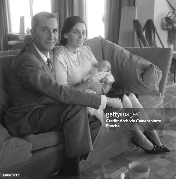 Italian actress Lucia Bose and the bullfighter Luis Miguel Dominguin holding the newborn Paola Dominguin Bose, Madrid, 1961.