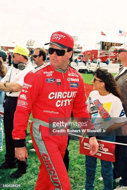 Waymond 'Hut' Strickalnd, wearing the colors of his Circuit City sponsor, walks to driver introductions prior to a Winston Cup race at Charlotte...