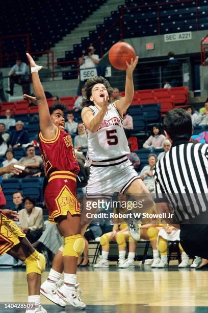 American basketball player Debbie Baer of the University of Connecticut drives past a University of Minnesota defender in a game at Gampel Pavilion,...