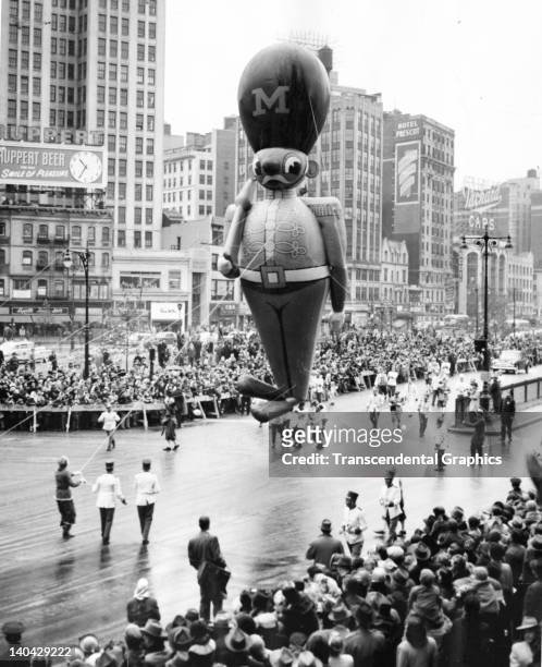 Giant toy soldier is the giant figure moving down a Manhattan avenue in Macy's Thanksgiving Parade on November 24, 1950. Chickens