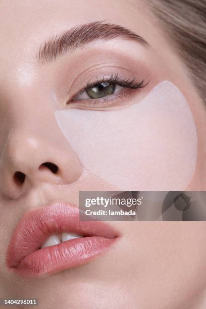 beautiful woman with under-eye patches - medical eye patch stockfoto's en -beelden