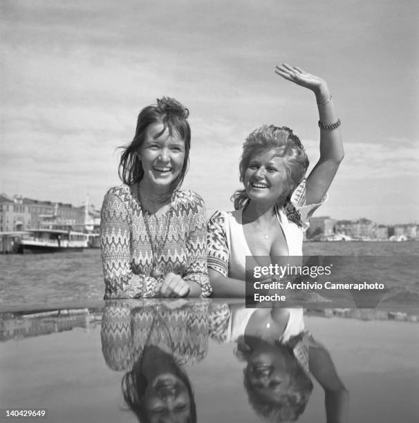 British actress Stephanie Beacham, on the right, standing on a water taxi with Verna Harvey, Venice, 1971.