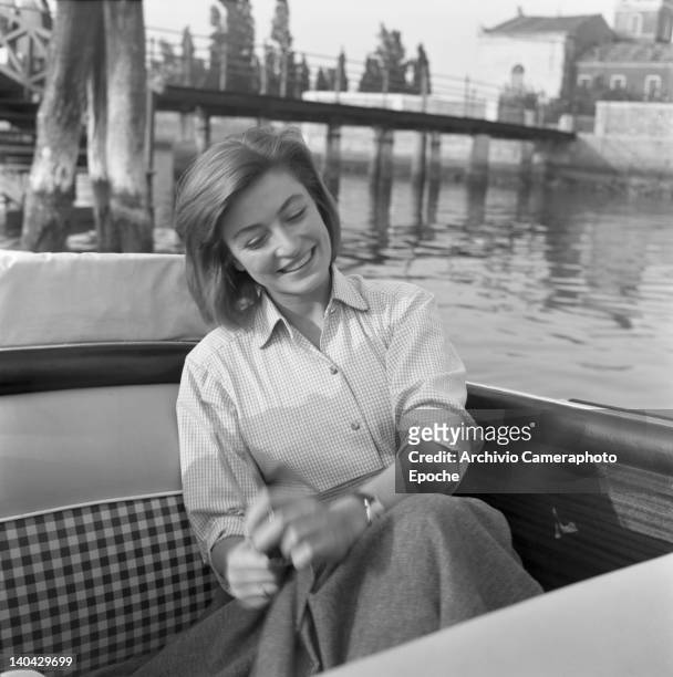 French actress Anouk Aimee portrayed while sitting on a boat, Venice, 1952.