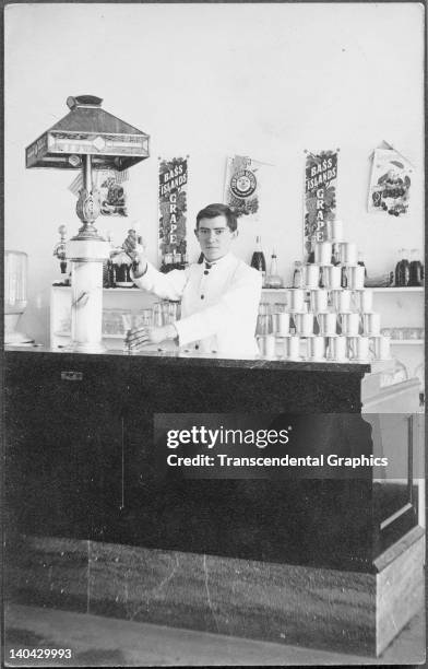 Soda jerk works at the counter in this real photo postcard from Bass Island, Michigan, circa 1910. Chickens