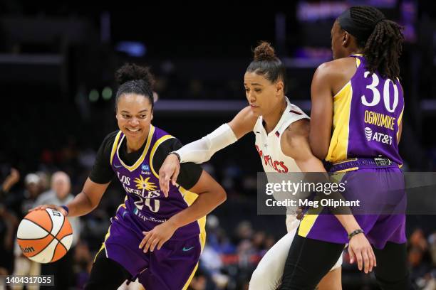 Kristi Toliver of the Los Angeles Sparks handles the ball in the first half against Natasha Cloud of the Washington Mystics at Crypto.com Arena on...