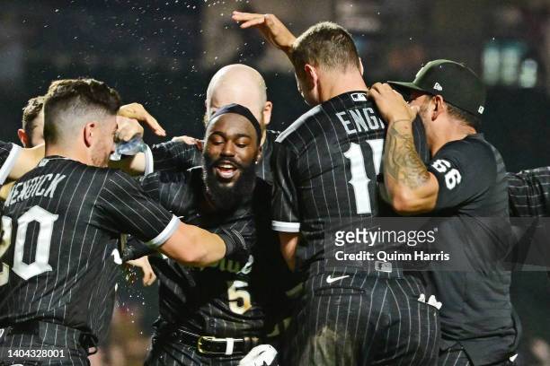 Josh Harrison of the Chicago White Sox celebrates with teammates after hitting a walk-off single in the 12th inning to defeat Toronto Blue Jays 7-6...