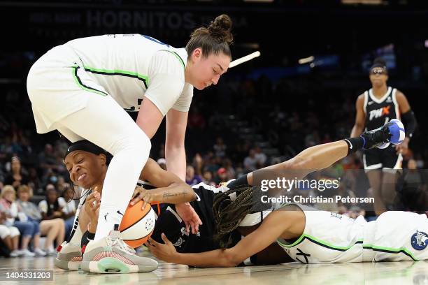 Shey Peddy of the Phoenix Mercury dives for a loose ball against Jessica Shepard and Moriah Jefferson of the Minnesota Lynx during the second half of...