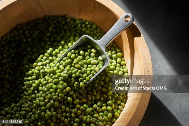 the scoop of mung bean in the wooden bucket - mung bean stock pictures, royalty-free photos & images