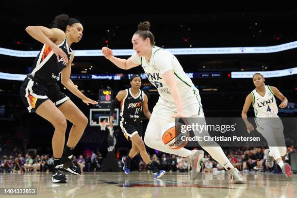 Jessica Shepard of the Minnesota Lynx drives the ball against Brianna Turner of the Phoenix Mercury during the first half of the WNBA game at...