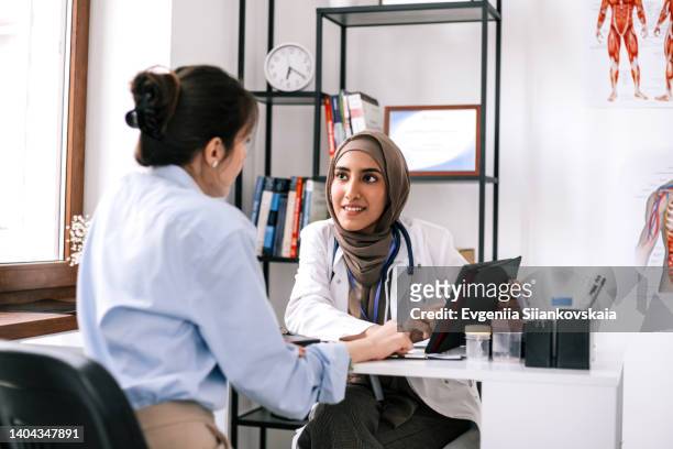 close up of a young woman having an asian doctor's appointment. - screening and discussion of foxs shots fired arrivals stockfoto's en -beelden