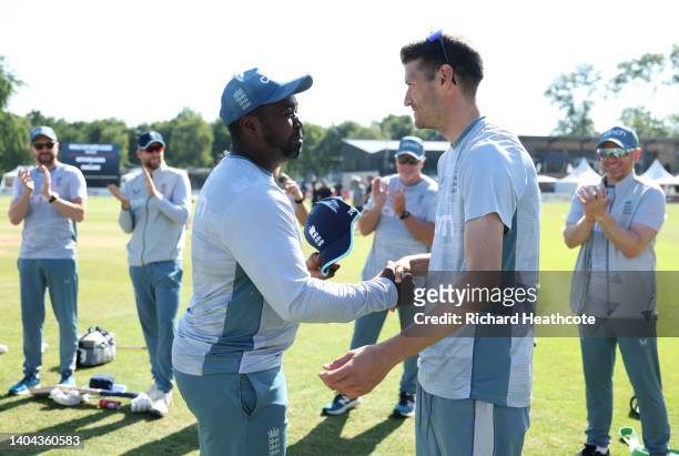 David Payne of England is presented with his first cap by batting coach Mark Alleyne during the 3rd One Day International between Netherlands and...