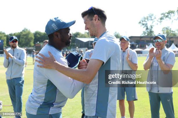 David Payne of England is presented with his first cap by batting coach Mark Alleyne during the 3rd One Day International between Netherlands and...