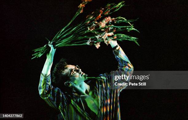 Morrissey of The Smiths waves a bunch of gladioli while performing on stage at Hammersmith Palais, on March 12th, 1984 in London, England.