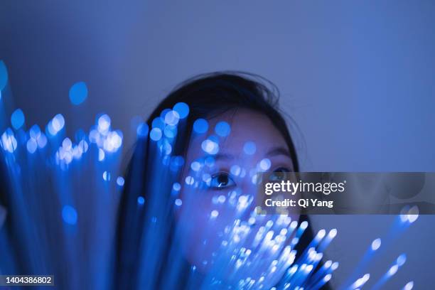 technology concept. young asian woman standing on glowing fiber optic background - digital trust stock pictures, royalty-free photos & images