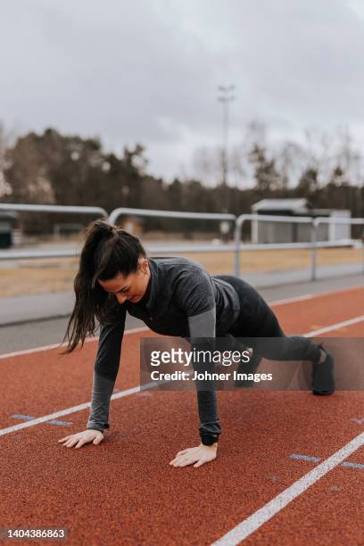 woman doing press-ups at running track - sports venue bildbanksfoton och bilder