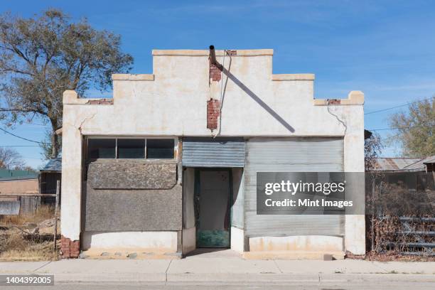 abandoned and boarded up building in a small town - boarded up stock pictures, royalty-free photos & images